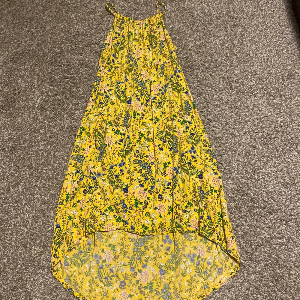 Yellow mid-calf length dress for girls. Pattern is blue and purple flowers.